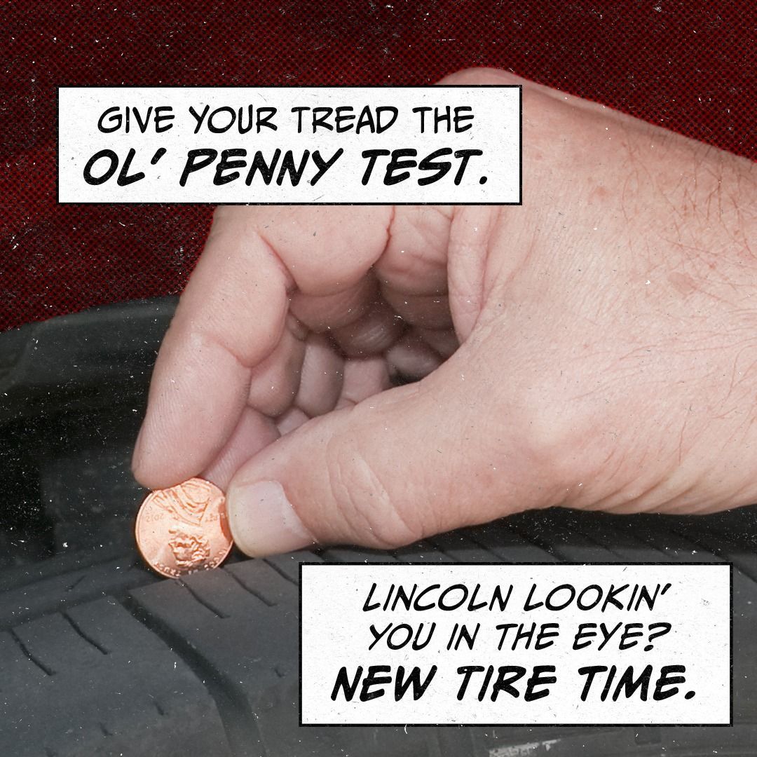A hand is putting a penny on a tire that says give your tread the ol penny test