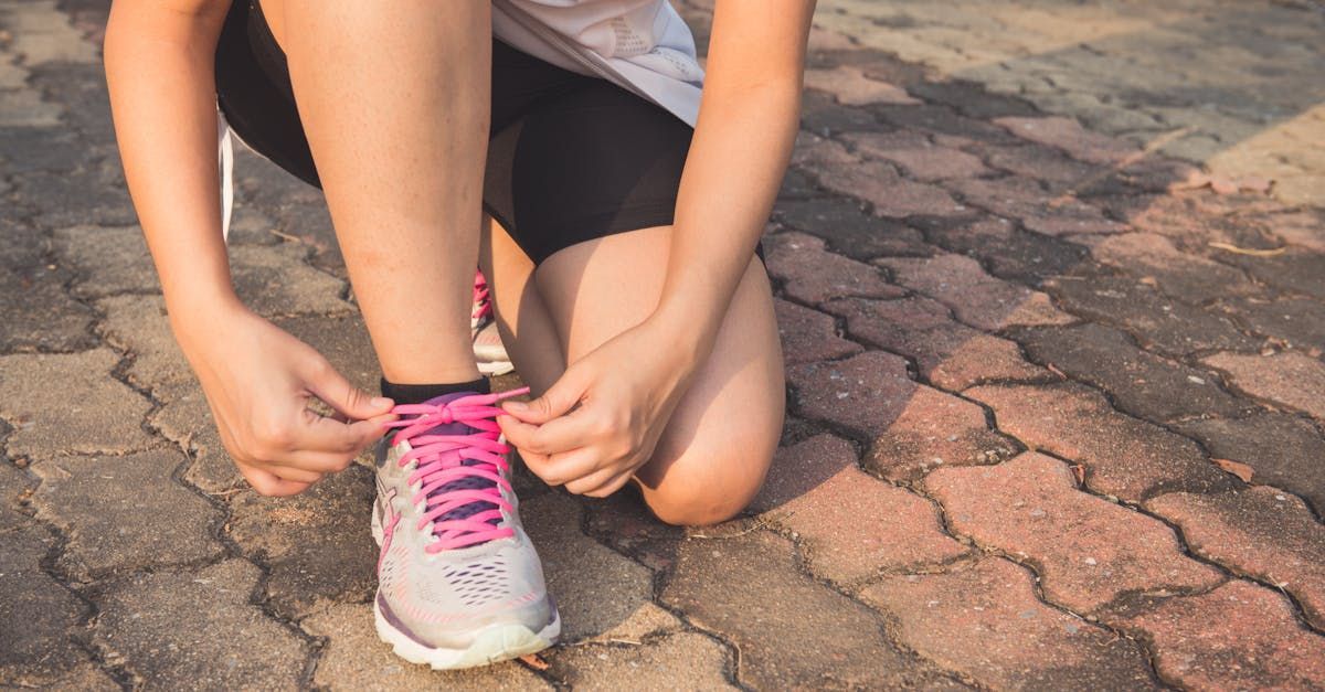 A woman tying a shoe