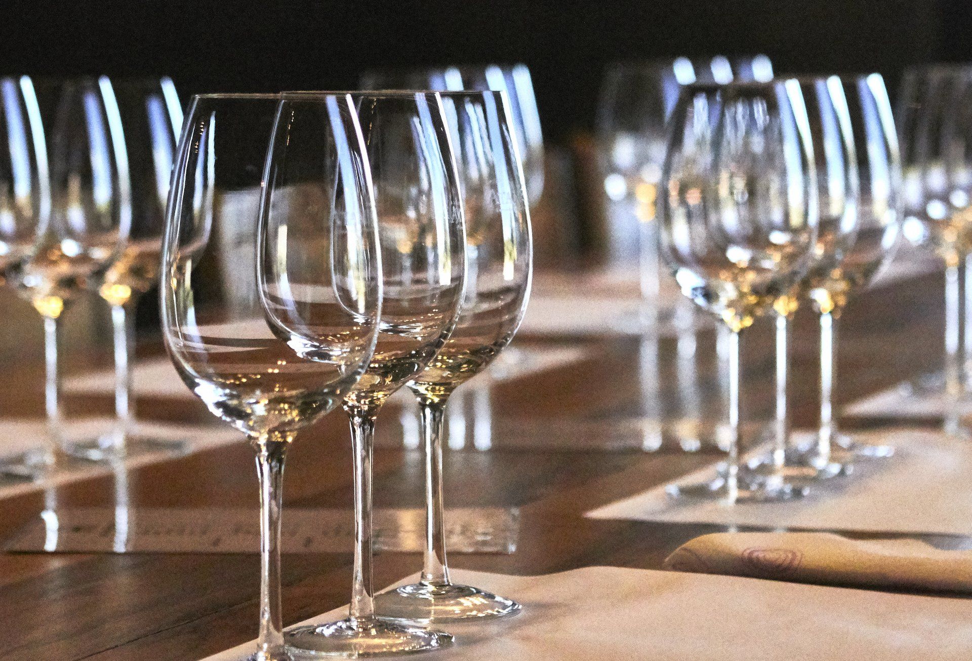 Empty wine glasses on a table, ready for a tasting. Mariposa Sedona