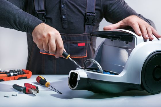 Repairman Repairing Vacuum Cleaner — Bellflower, CA — A-Rodgers Vacuum & Sewing