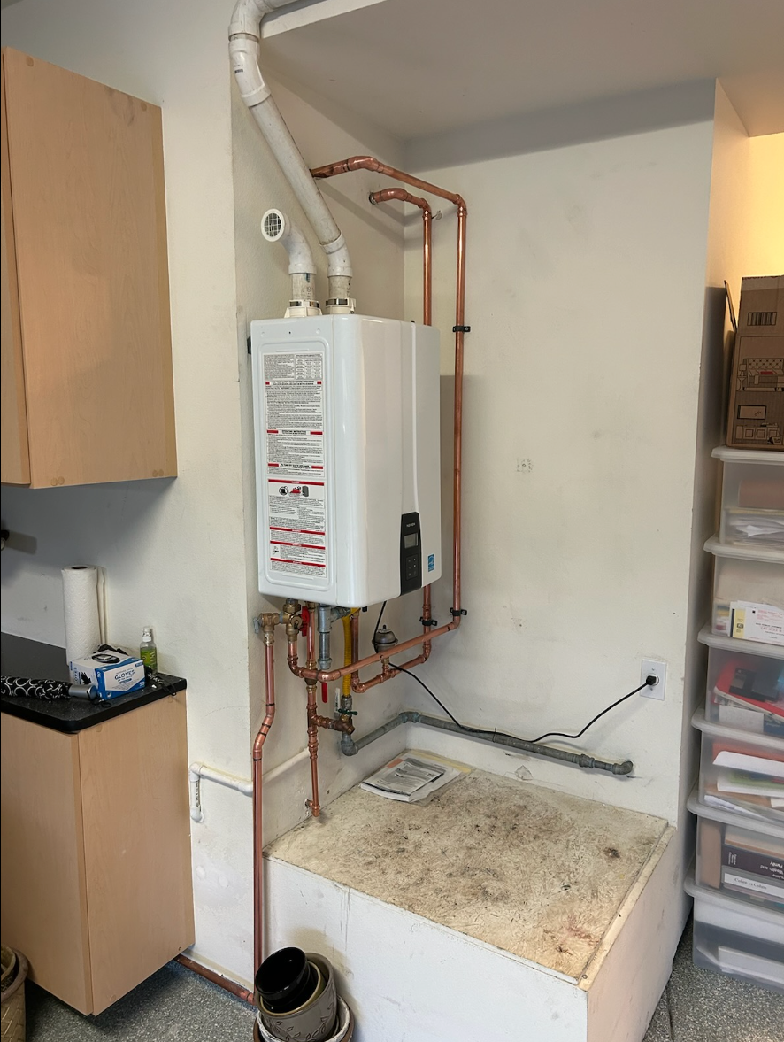 A water heater is sitting on top of a counter in a kitchen.