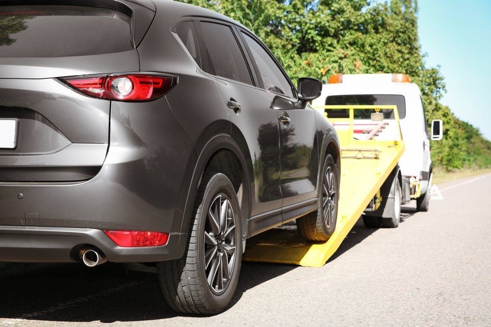 A Gray Suv Being Loaded onto A Tow Truck — A1 Towing in Lake Macquarie, NSW