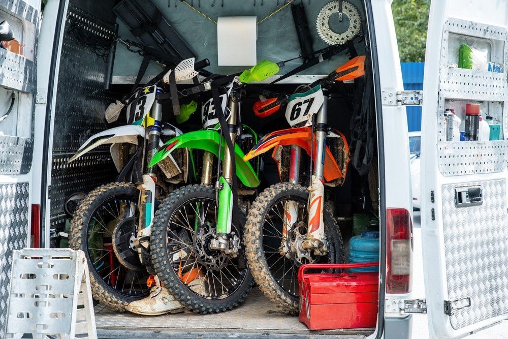 Three Dirt Bikes Packed Inside a Van — A1 Towing in Blue Haven, NSW