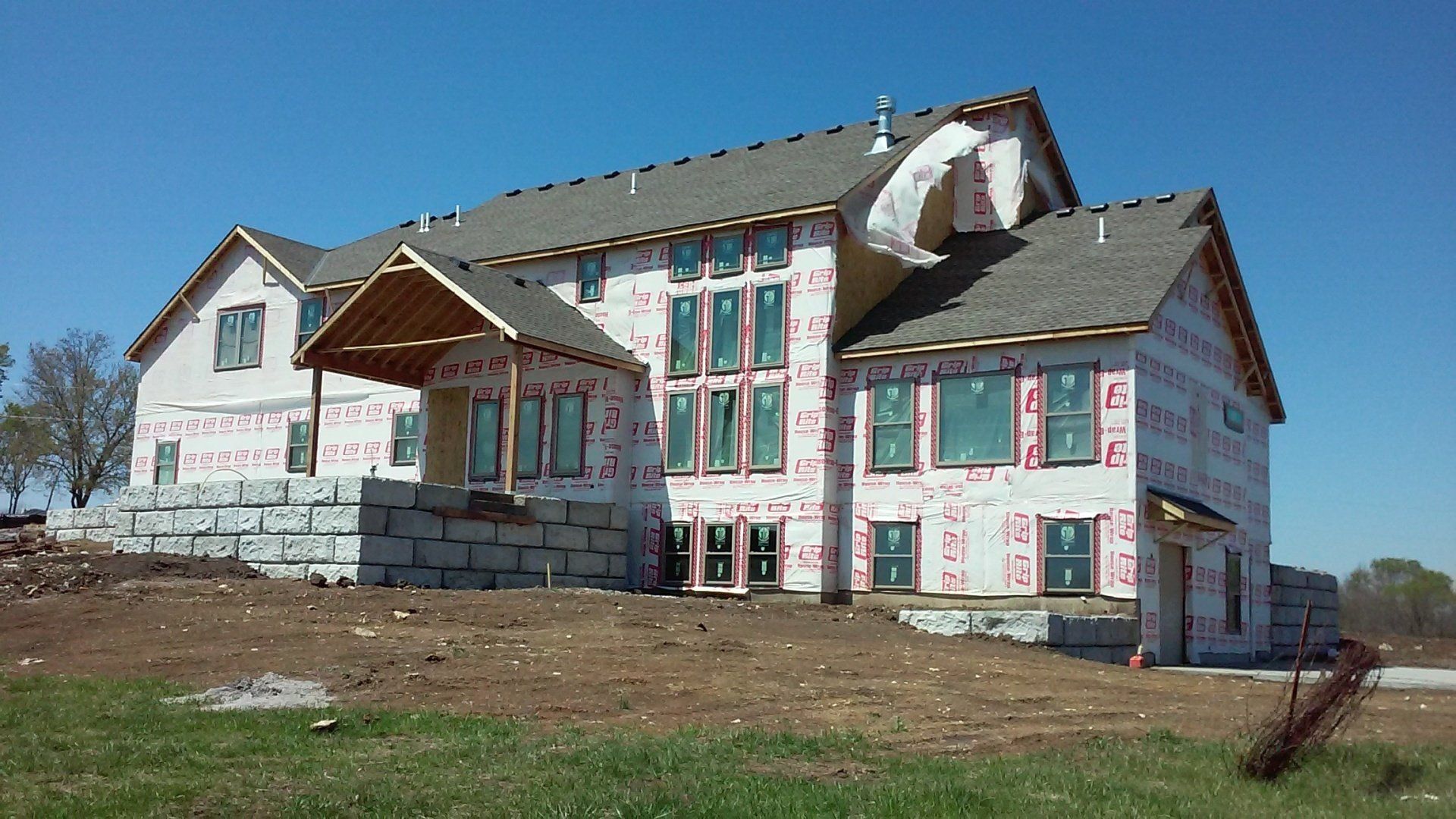 A large house with a lot of windows is being built