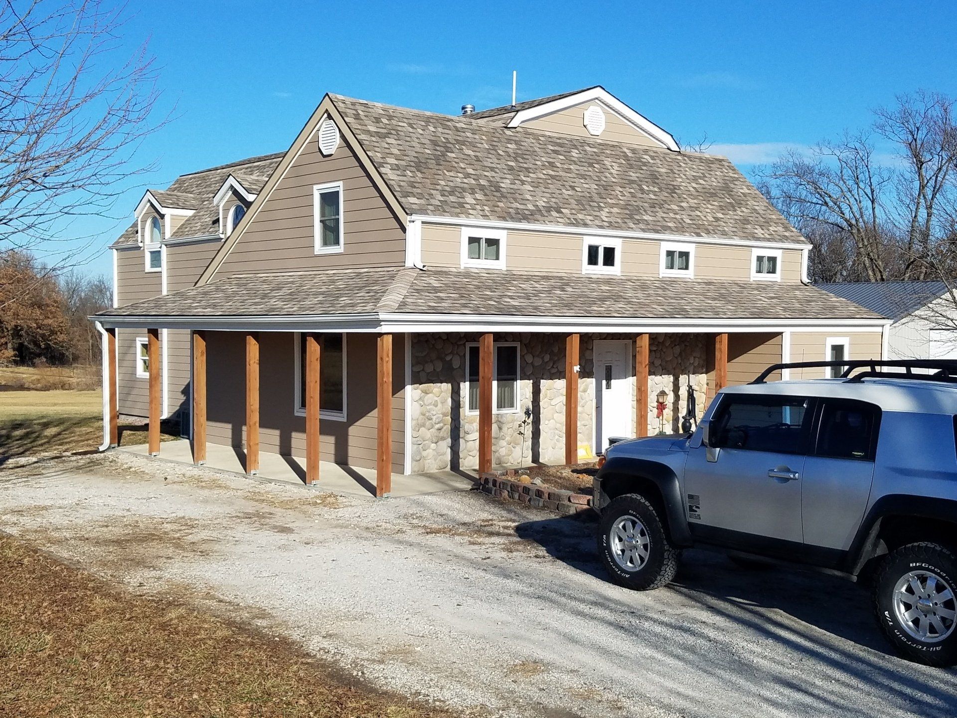 A jeep is parked in front of a large house