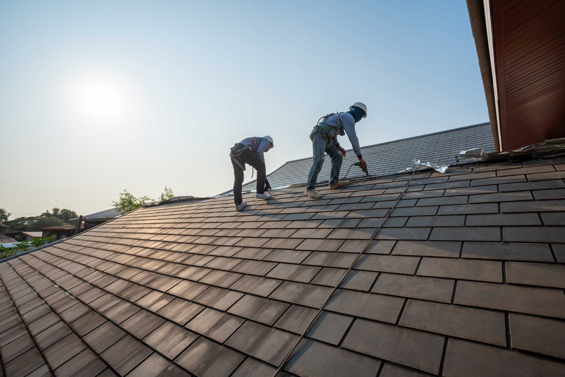Roofer working in special protective work wear gloves.