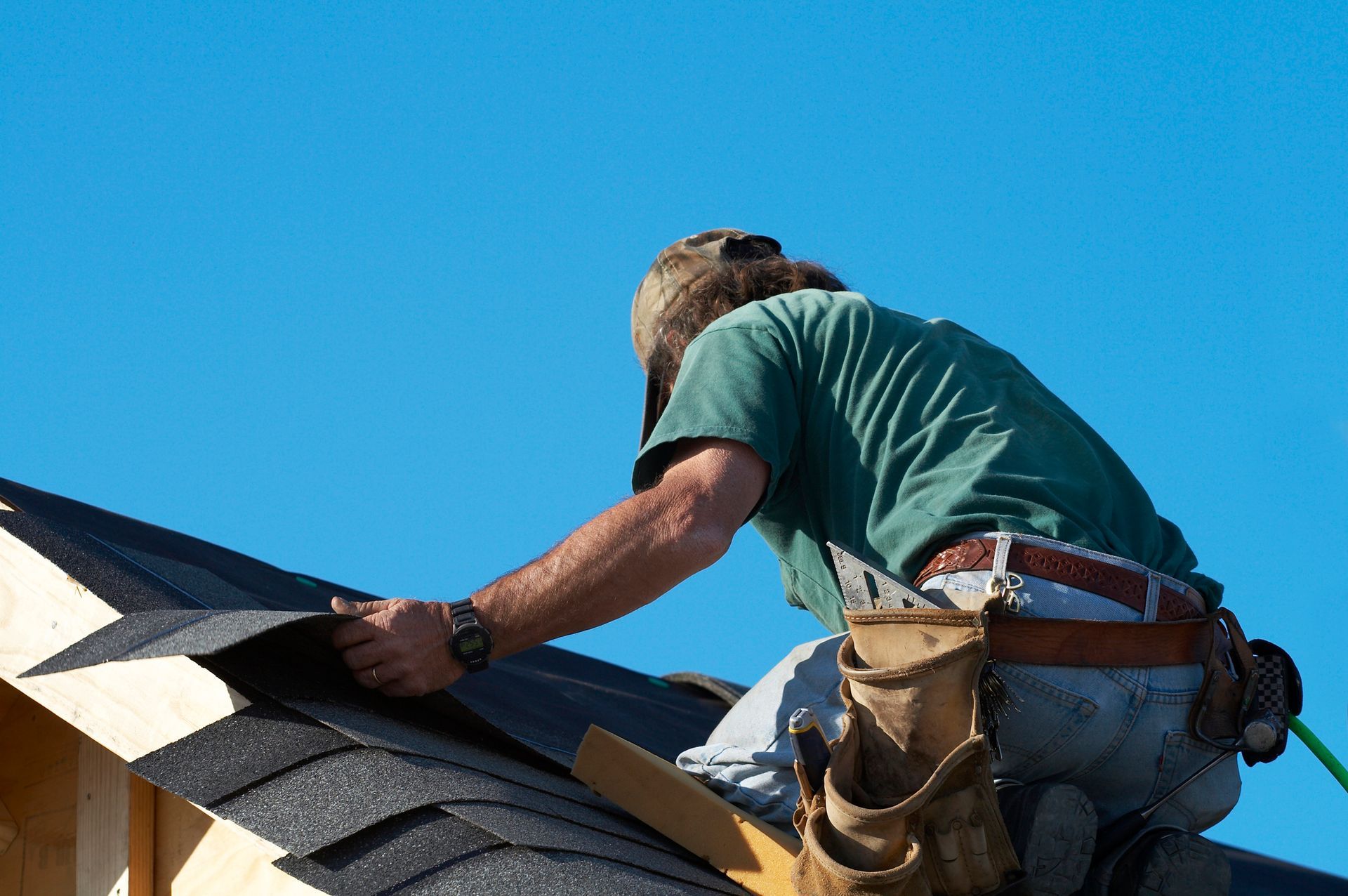 A builder working on a new roof installation for Meissen and Sons Roofing in Belton, MO