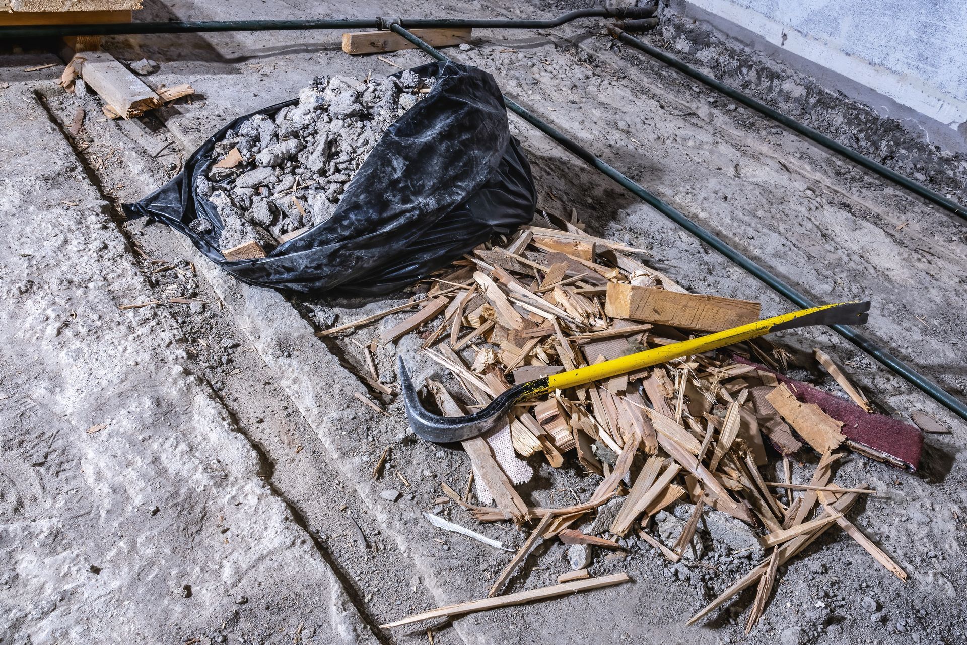 a pile of wood chips and a hammer on the floor .