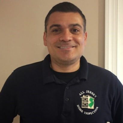 A man wearing a shirt that says all jersey home inspection