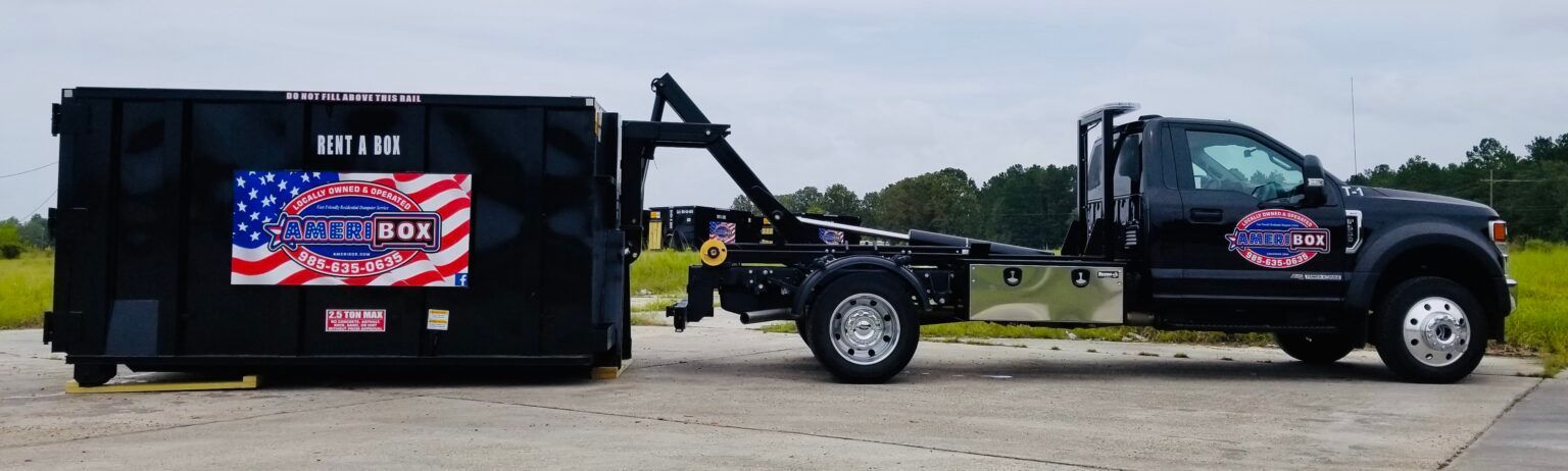 A picture of a dumpster truck delivering a dumpster to a parking lot in Mandeville, LA.