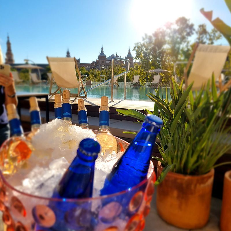 A bucket of ice with blue bottles in it