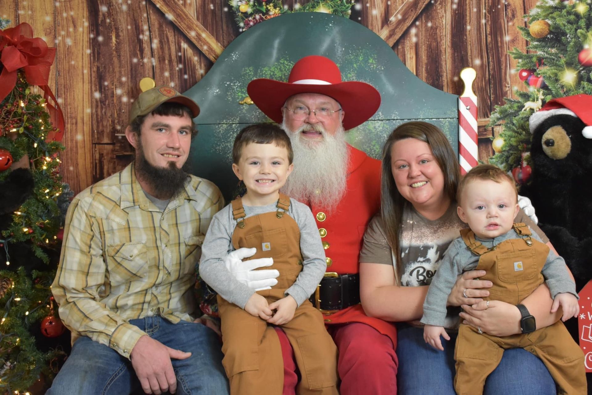 A family is posing for a picture with santa claus.