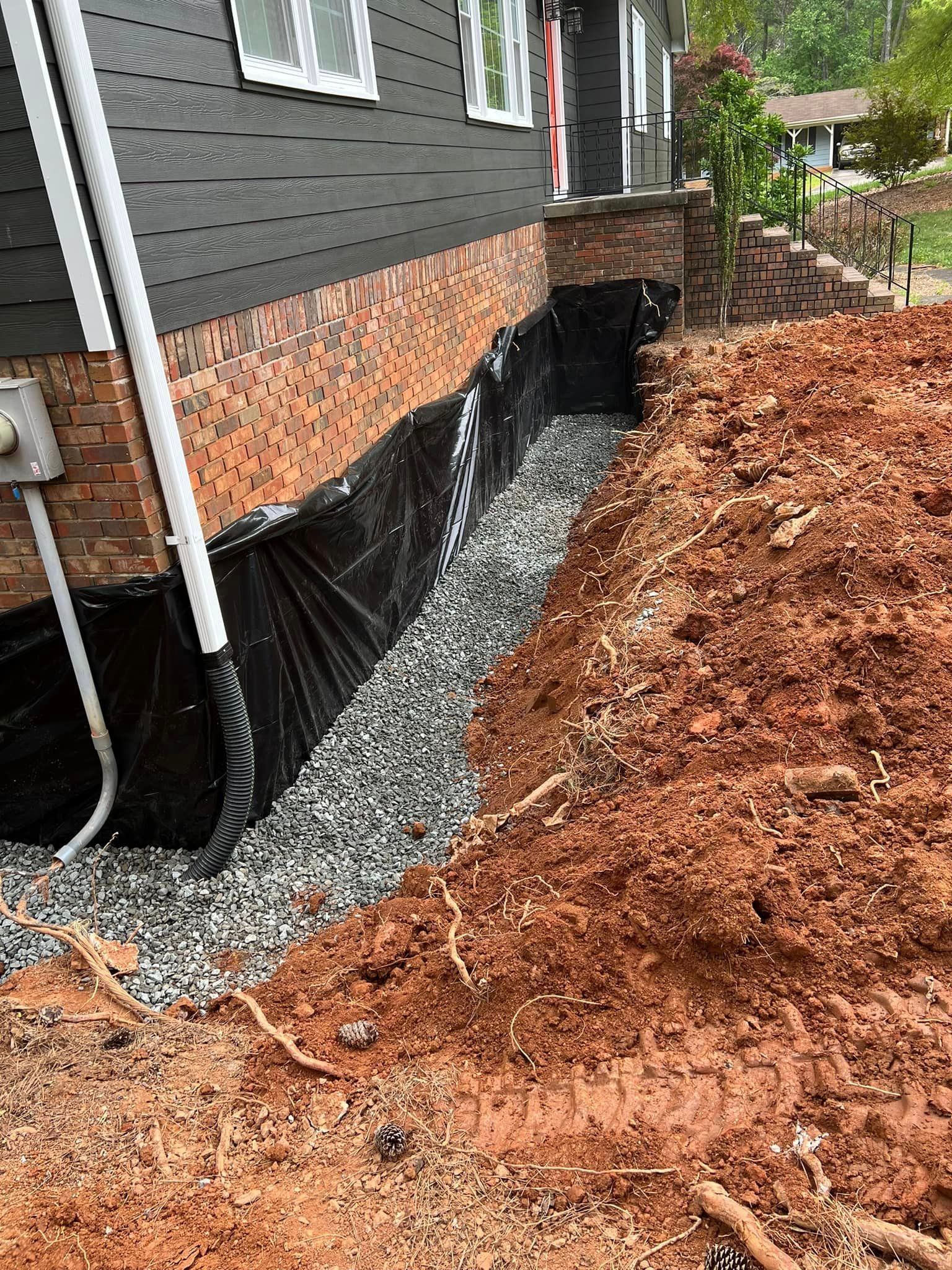 A pile of dirt is sitting in front of a house.