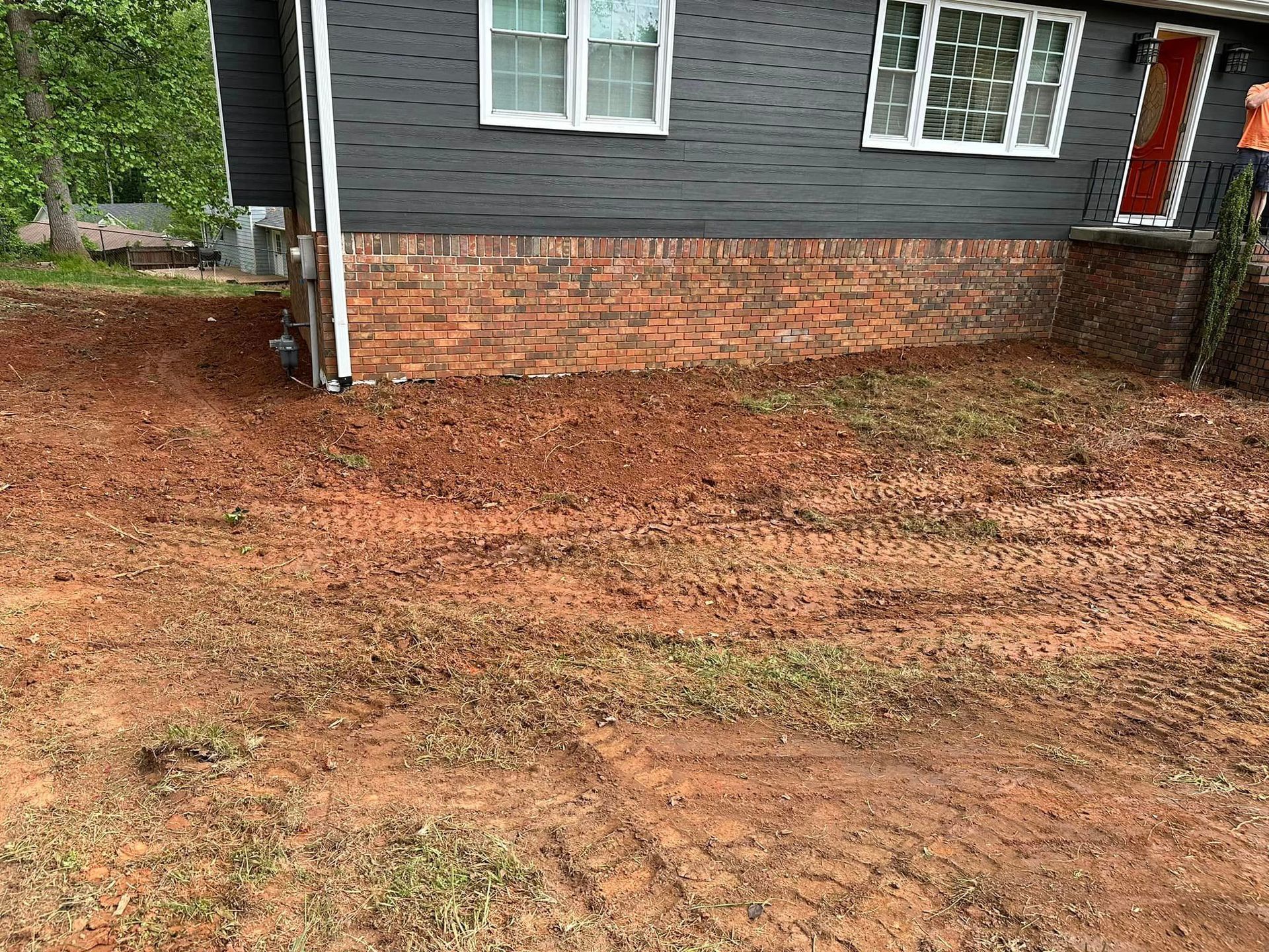 A house with a lot of dirt in front of it.