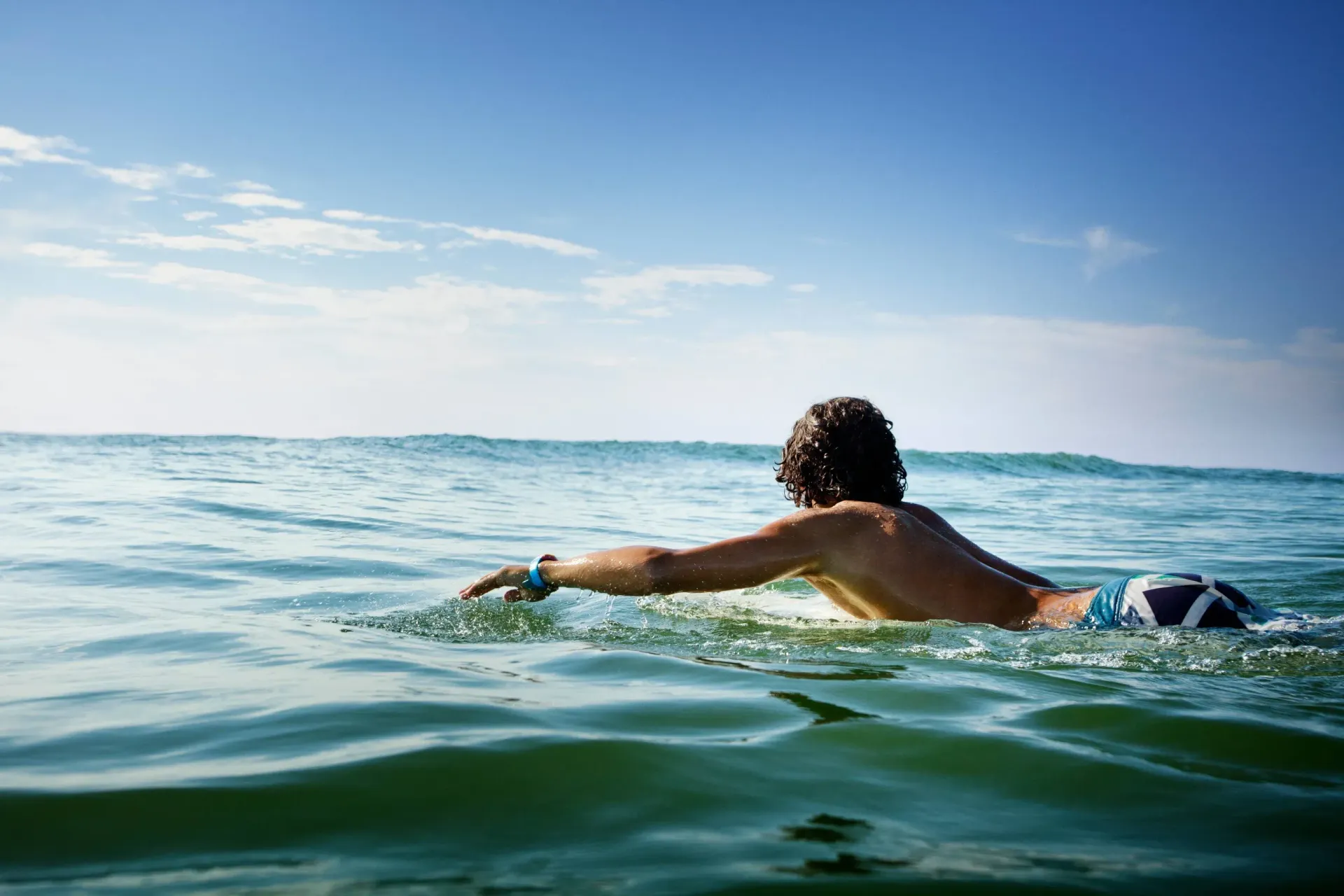 Surfer swimming out to catch his next wave.