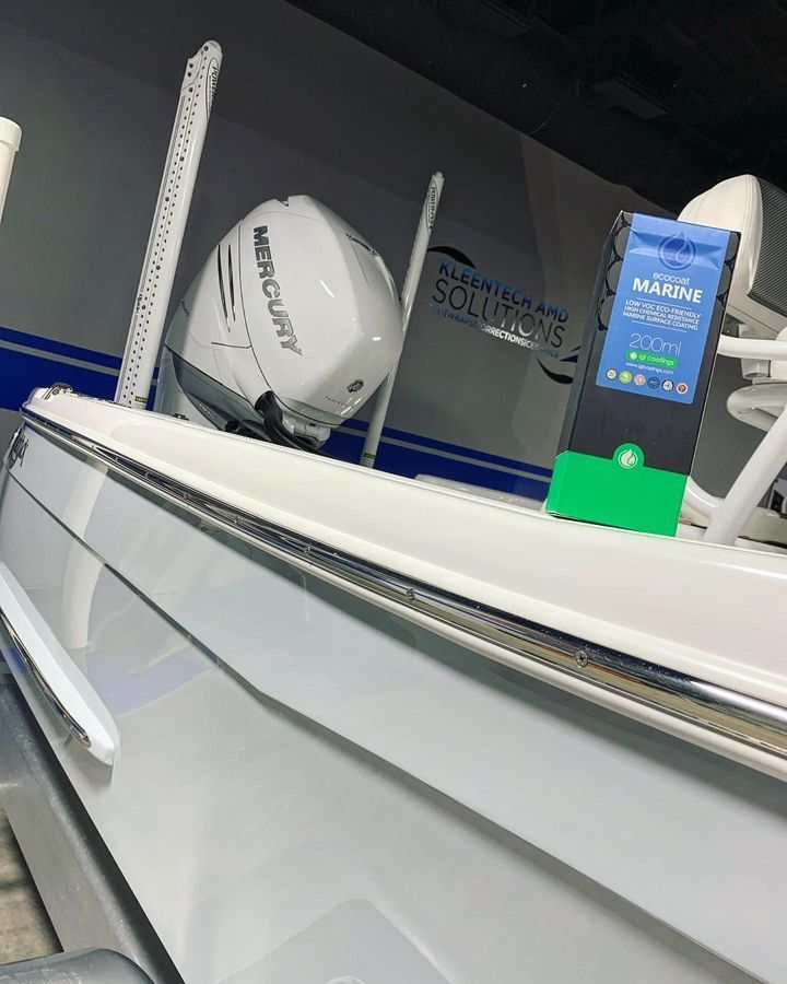 White boat with a Mercury engine and a bag of