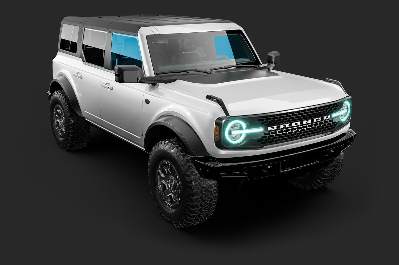 White Ford Bronco SUV on dark background with black accents and off-road tires.