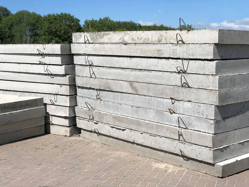 Stacks of Grey Concrete Slabs With Metal Loops, Outdoors — Atherton Tableland Concreting in Yungaburra, QLD
