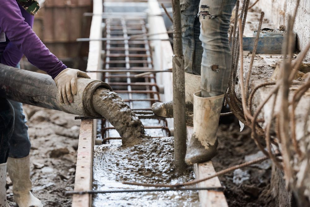 Workers Pouring Concrete Into a Formwork — Atherton Tableland Concreting in Yungaburra, QLD