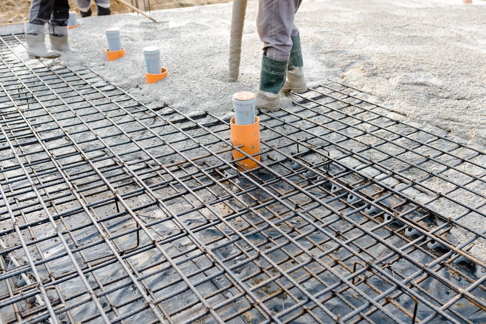 Construction Workers Pouring Concrete Over Rebar Grid — Atherton Tableland Concreting in Yungaburra, QLD