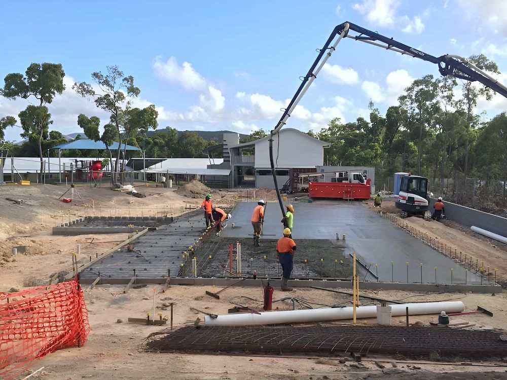 A Group of Construction Workers Are Working on a Concrete Floor — Atherton Tableland Concreting Pty Ltd in Yungaburra, QLD