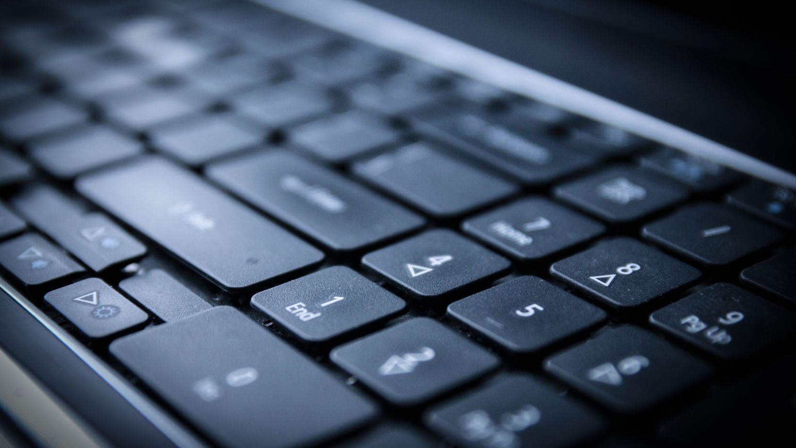 A close up of a laptop keyboard with the shift key visible