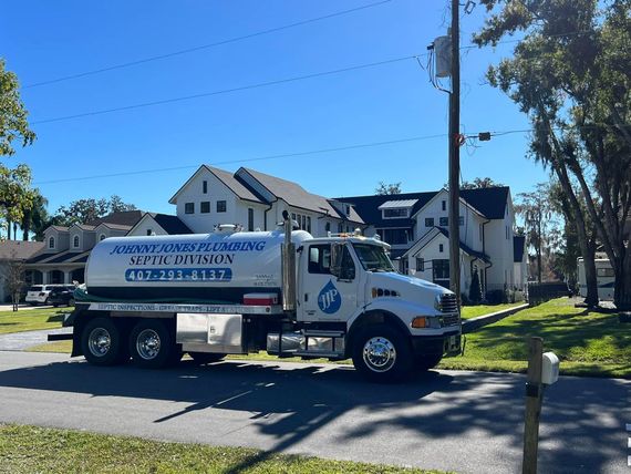 A white truck with a blue sticker on the side that says ' water cleaning '