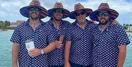 Four men wearing cowboy hats and sunglasses are standing next to each other on a boat.