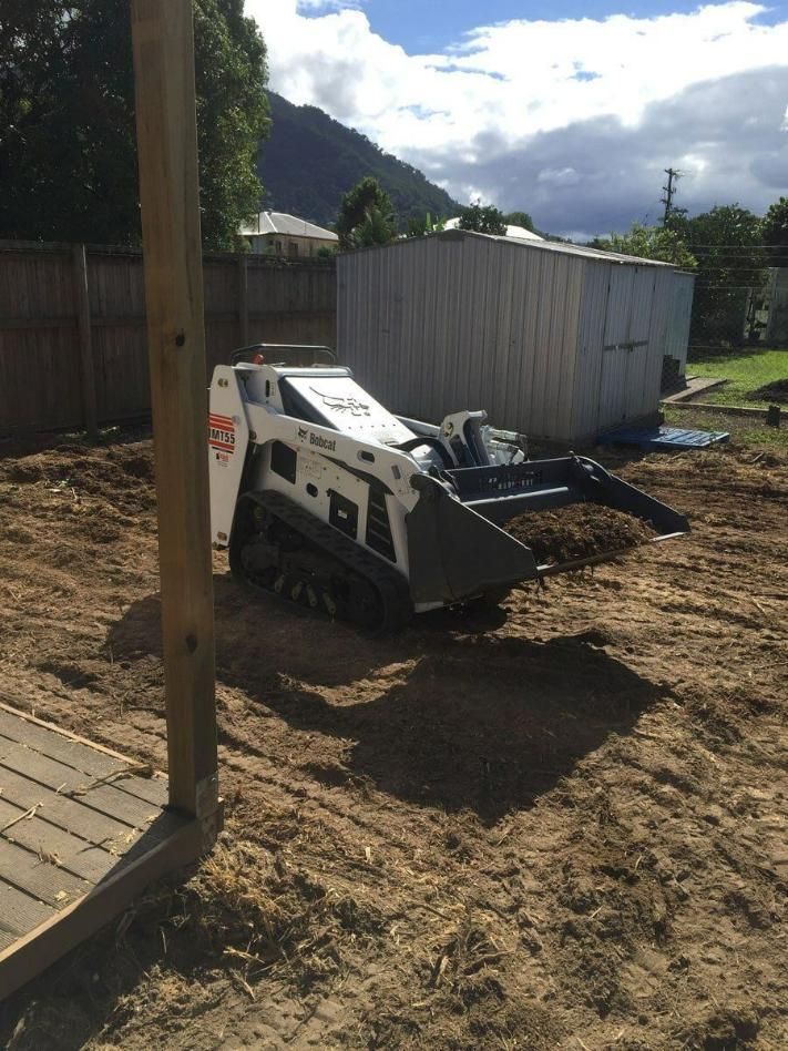 A Small Bulldozer Is Sitting in The Dirt in A Backyard — Advanced Vegetation Management in Stratford, QLD