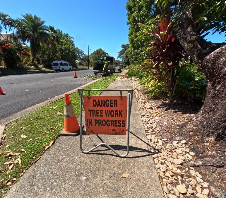 A Sign on The Sidewalk Says Danger Tree Work in Progress — Advanced Vegetation Management in Freshwater, QLD