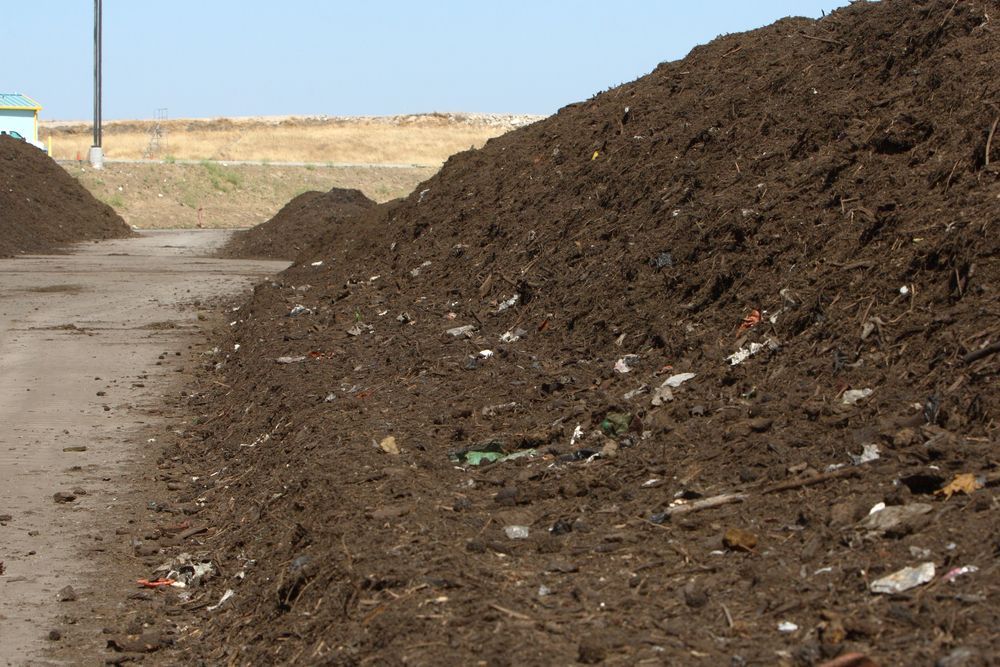 A Pile of Dirt is Sitting on the Side of a Road — Dubbo Soils & Landscaping Supplies in Wellington, NSW