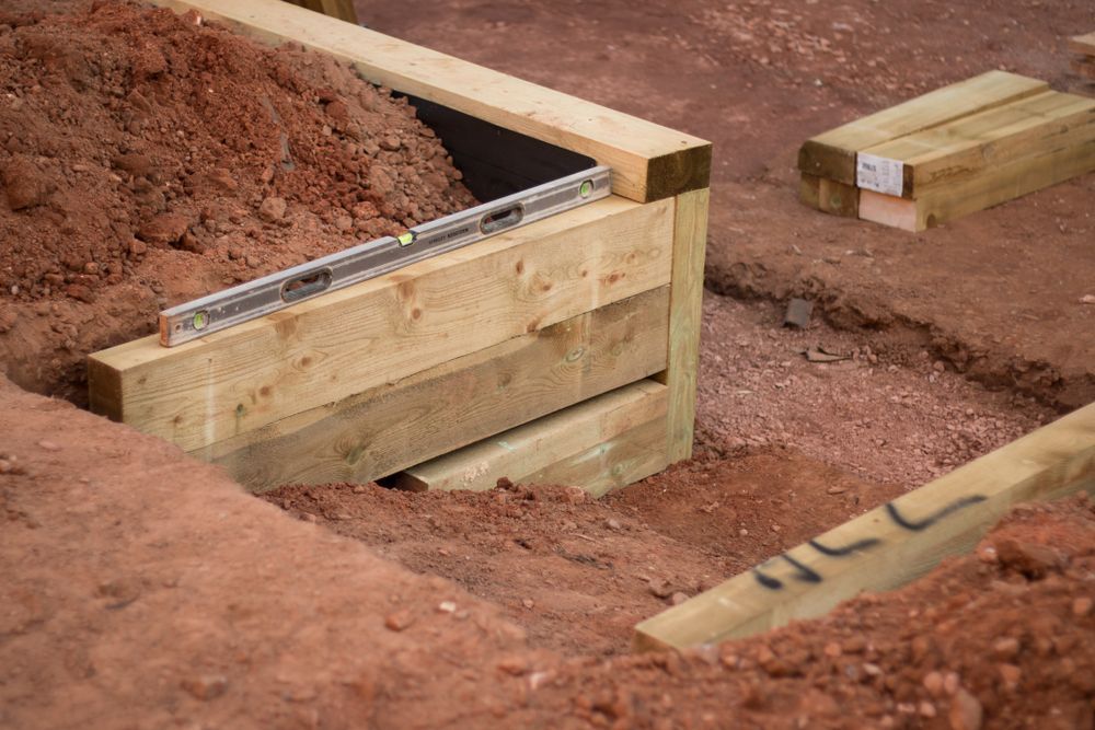 A Wooden Box is Sitting on Top of a Pile of Dirt — Dubbo Soils & Landscaping Supplies in Gilgandra, NSW