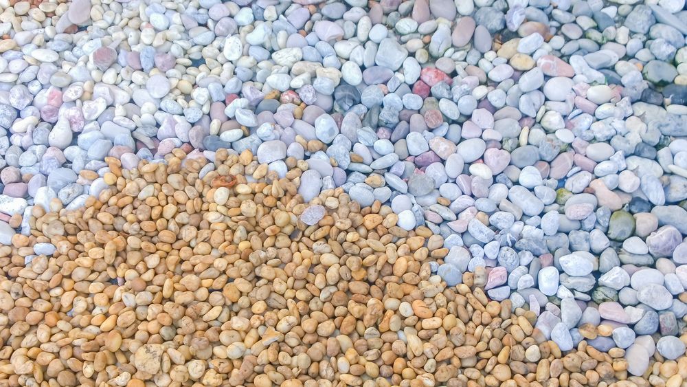 Three Piles of Small, Rounded Pebbles: Tan, Light Blue, and a Mix of Light Blue and Pink.