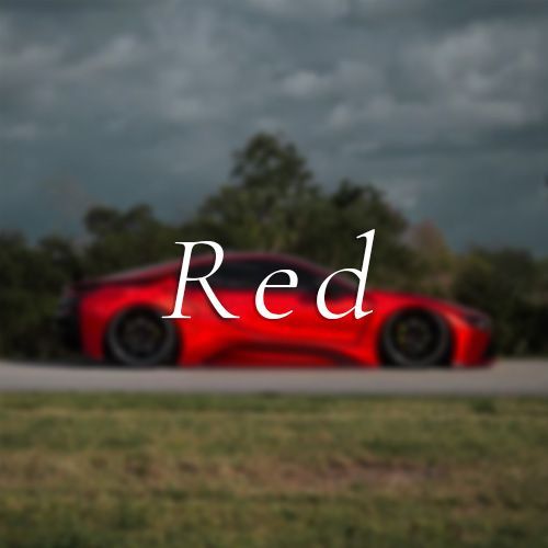 A red car is driving down a road with the word red above it