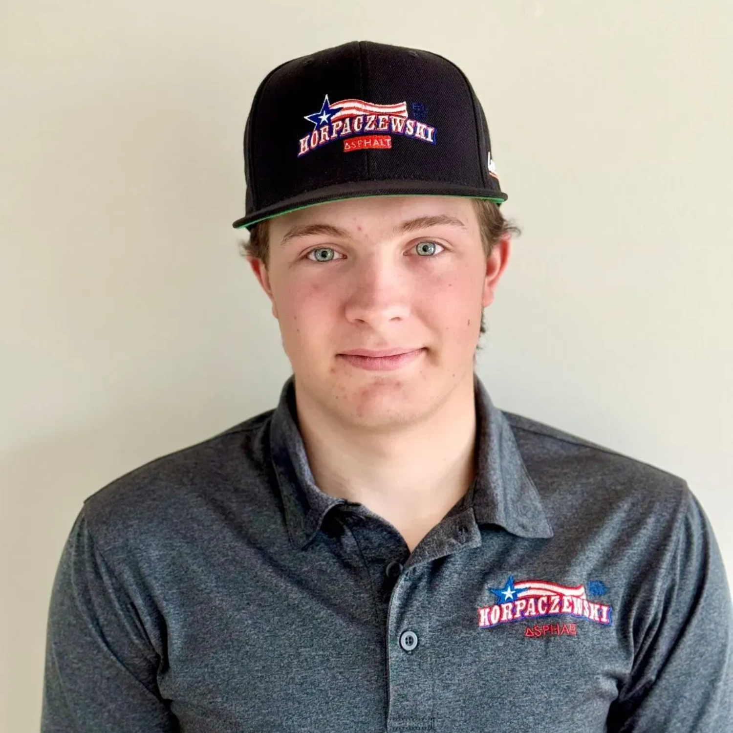 Man wearing a cap and polo shirt with