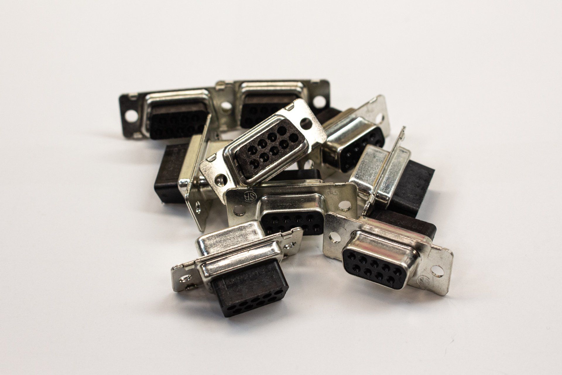 A bunch of connectors are stacked on top of each other on a white surface.