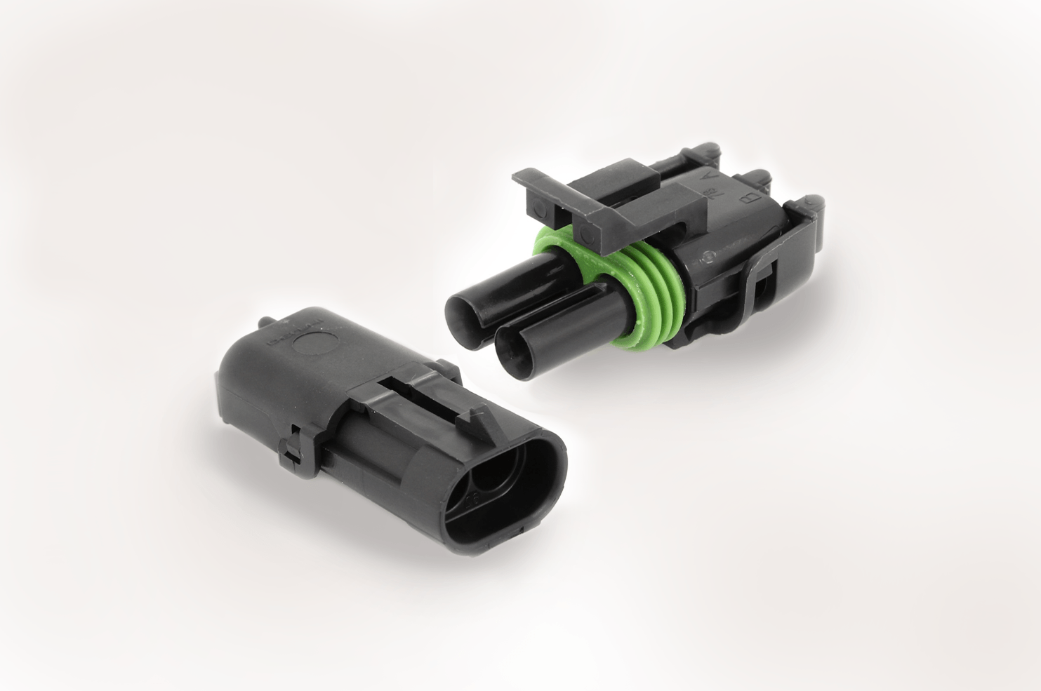 A couple of black connectors on a white surface.