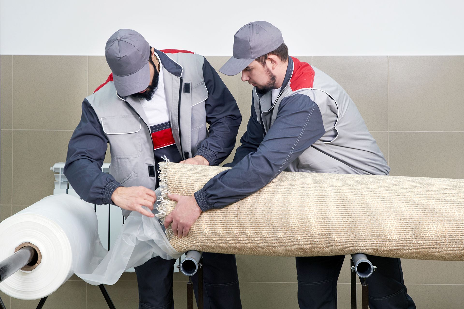 Two men are working on a large piece of wood