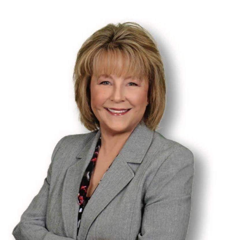 Blonde haired woman in grey suit