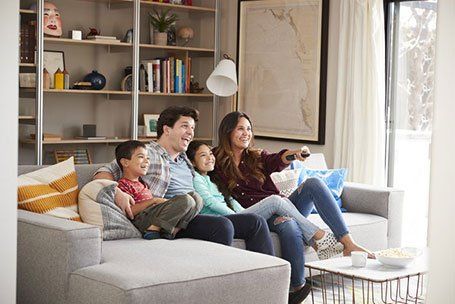Happy Family Watching TV — Tilton, IL — Blackie's Heating And Cooling