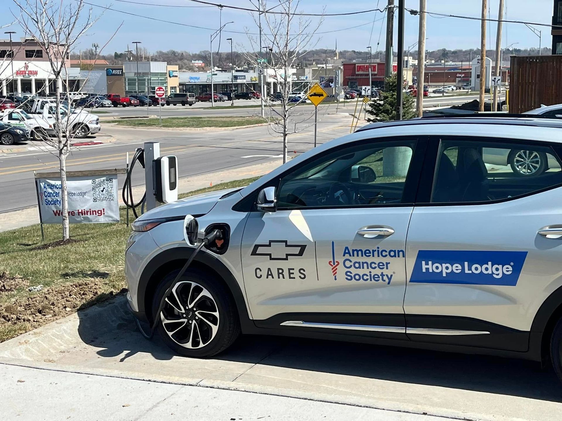 A chevrolet car is being charged by the american cancer society