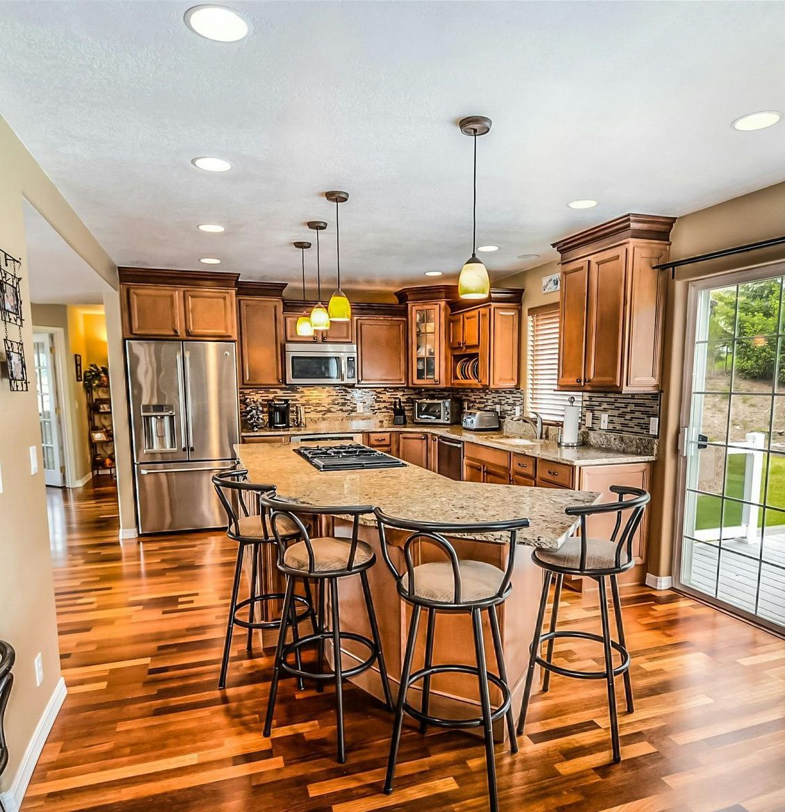 A kitchen with stainless steel appliances and wooden cabinets