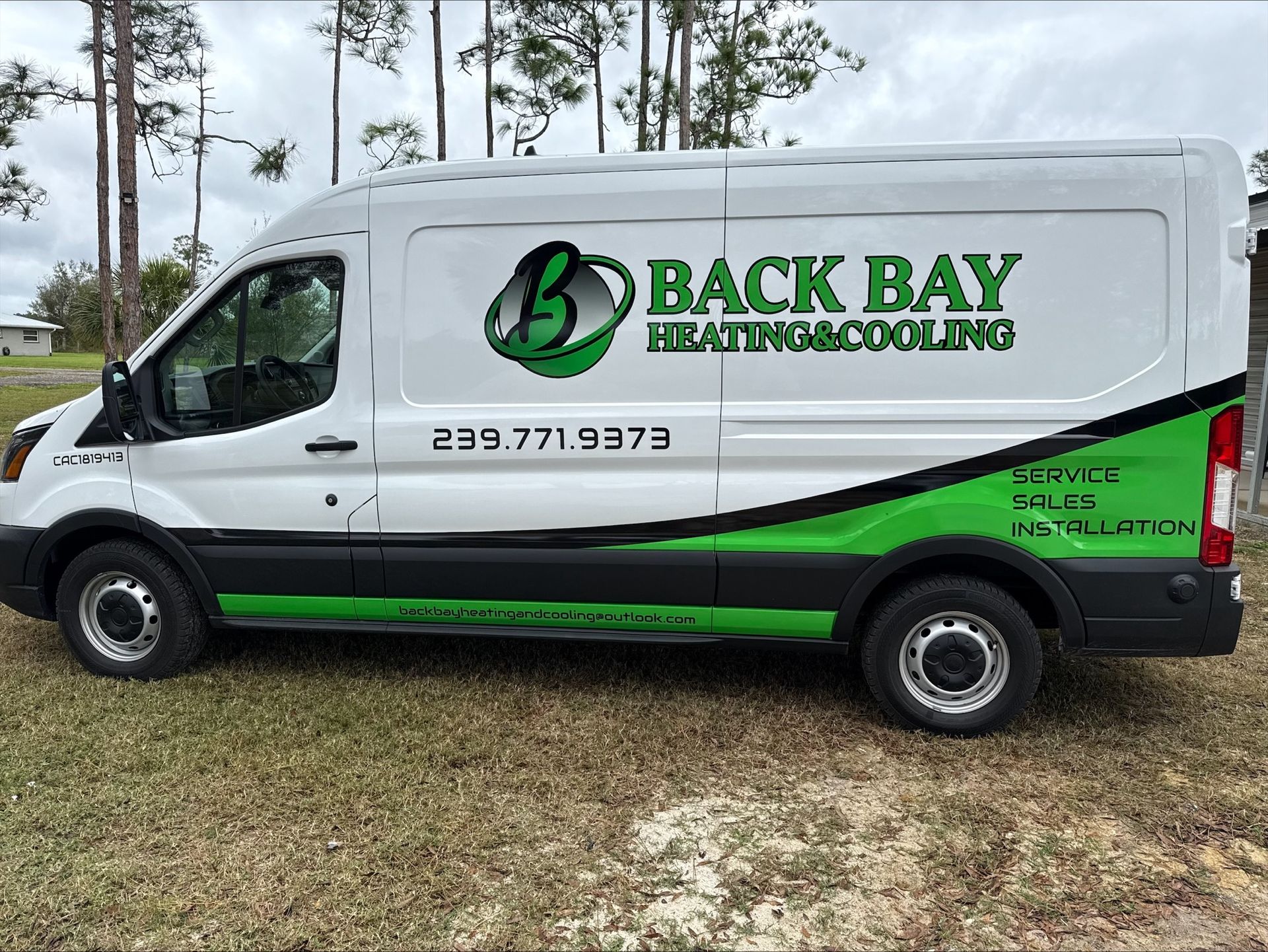 White van with Back Bay Heating & Cooling logo; green and black accents; phone number on side.