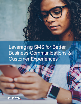 A woman wearing glasses is looking at her cell phone