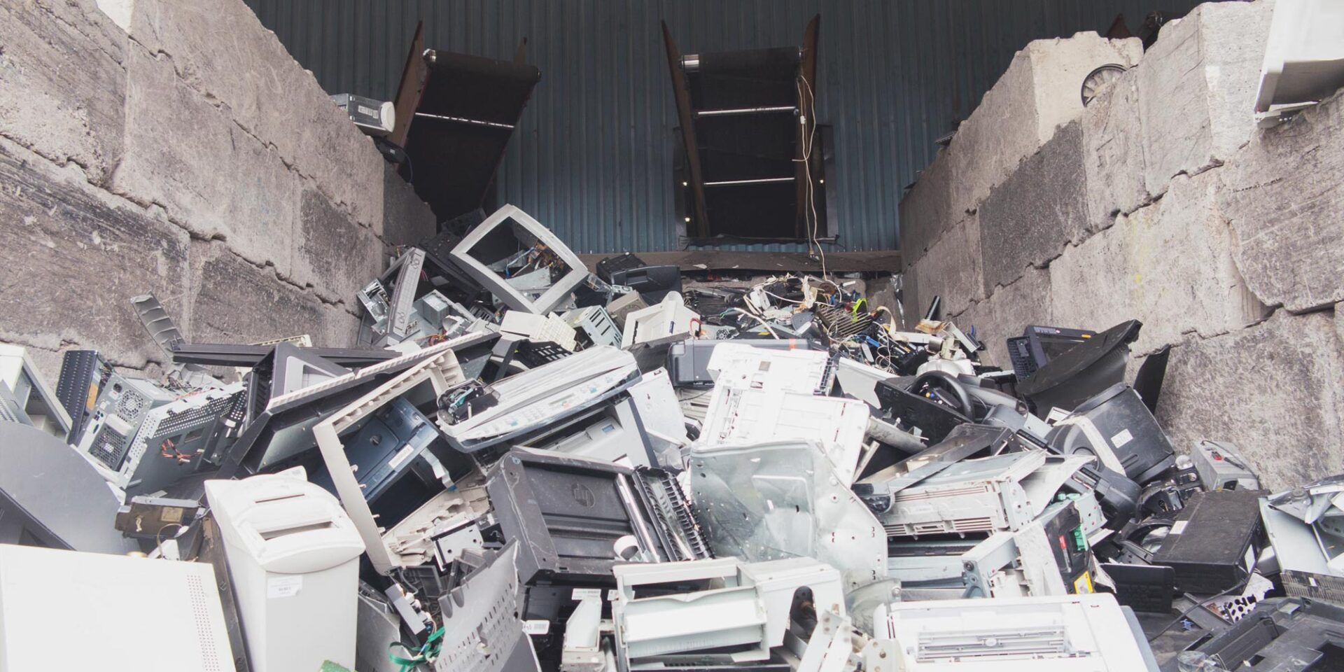 A pile of electronic waste is sitting on top of a pile of concrete blocks