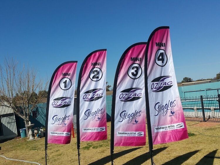 A row of pink and white flags with the word s on them — Mountain City Signs In West Tamworth, NSW