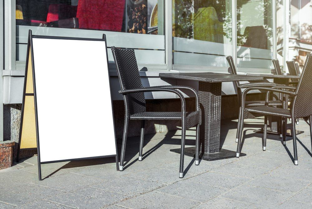 A Row of Tables and Chairs Outside of a Restaurant — Mountain City Signs In West Tamworth, NSW