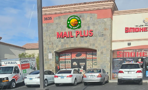 A mail plus store with cars parked in front of it