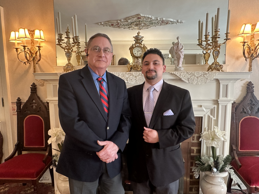 Funeral Directors Roy F. Bordeau and Nicholas J. Facci are posing for a picture together in their funeral home.