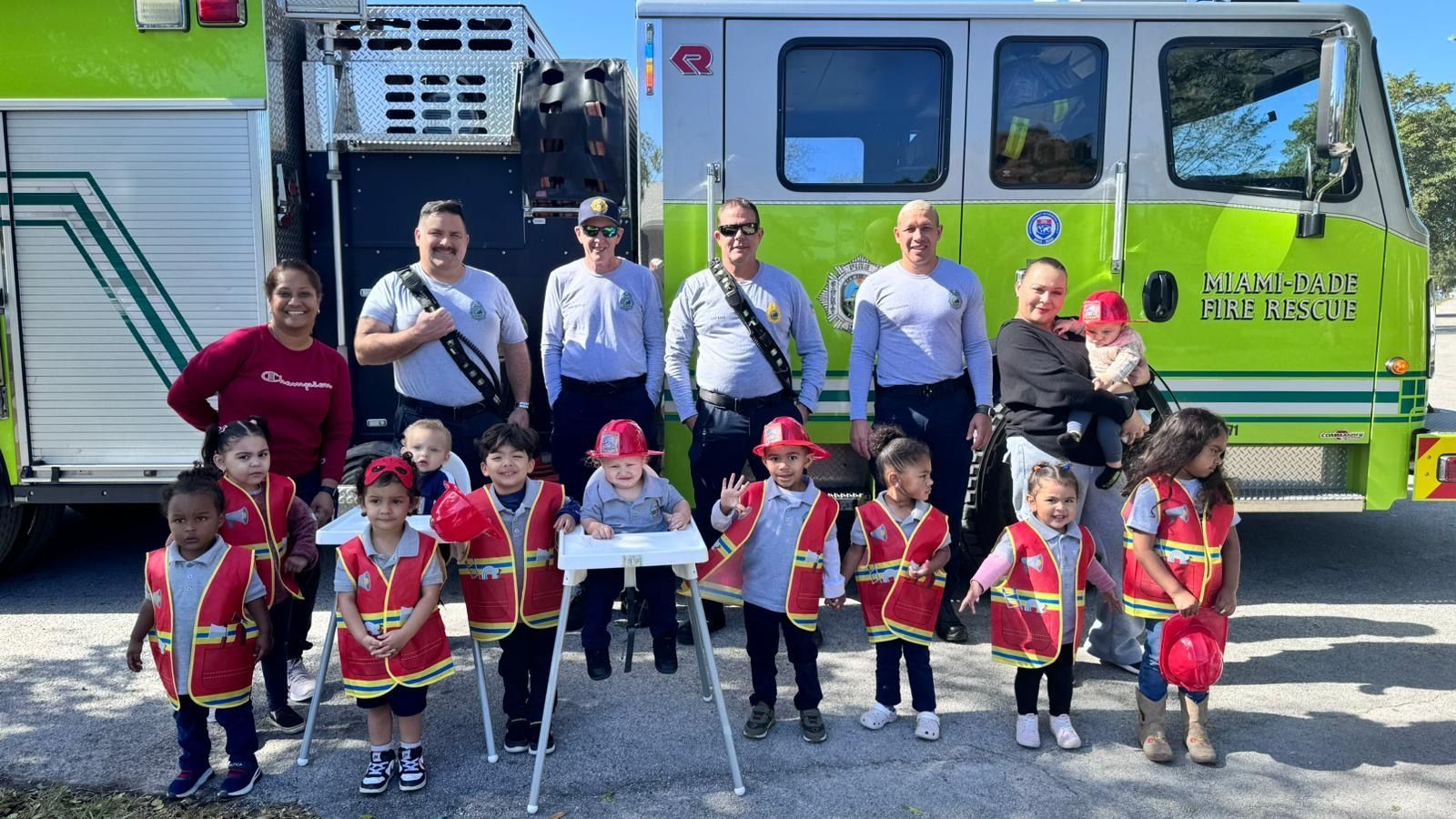 A group of children are posing for a picture in front of a fire truck.